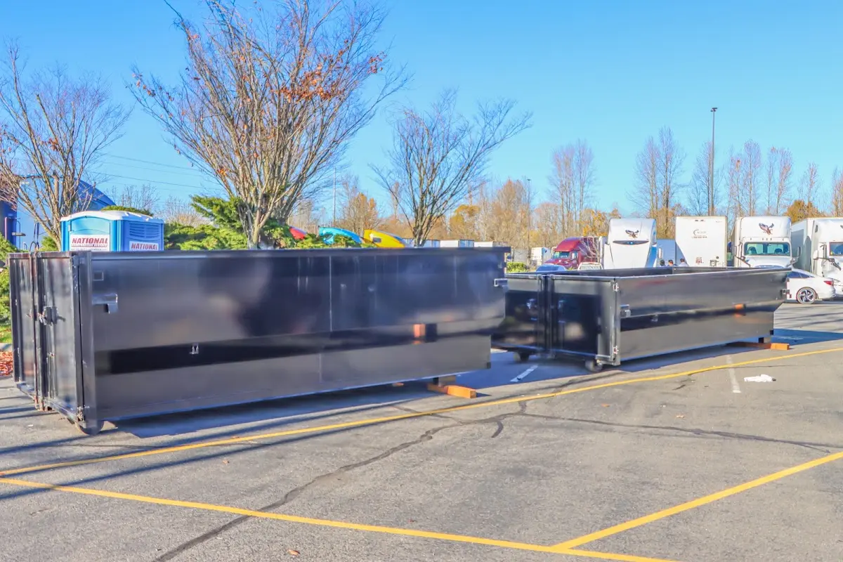 Professional dumpster rental service with roll-off container on residential driveway in Saranap